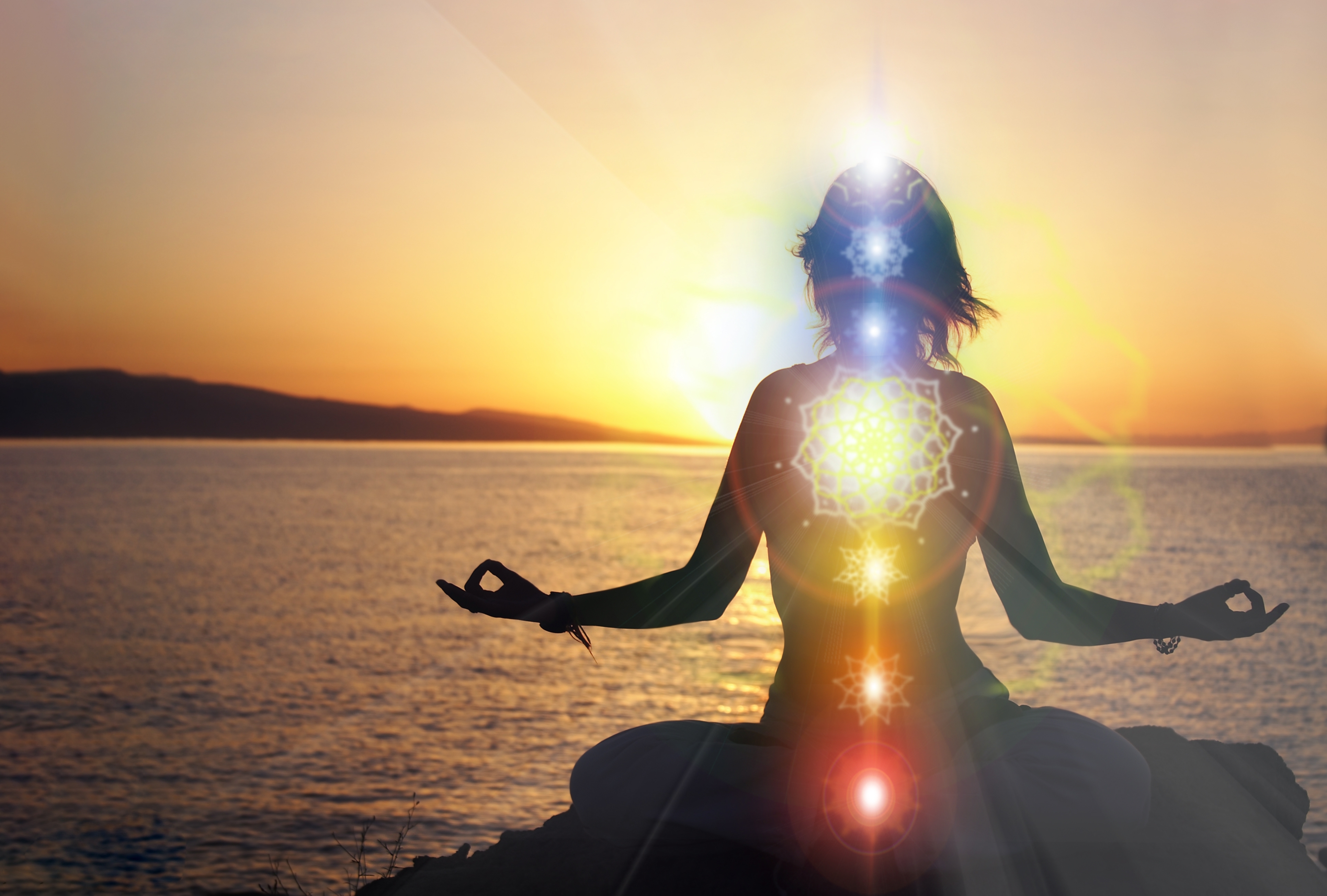 Enlightened person meditating on the beach at sunset