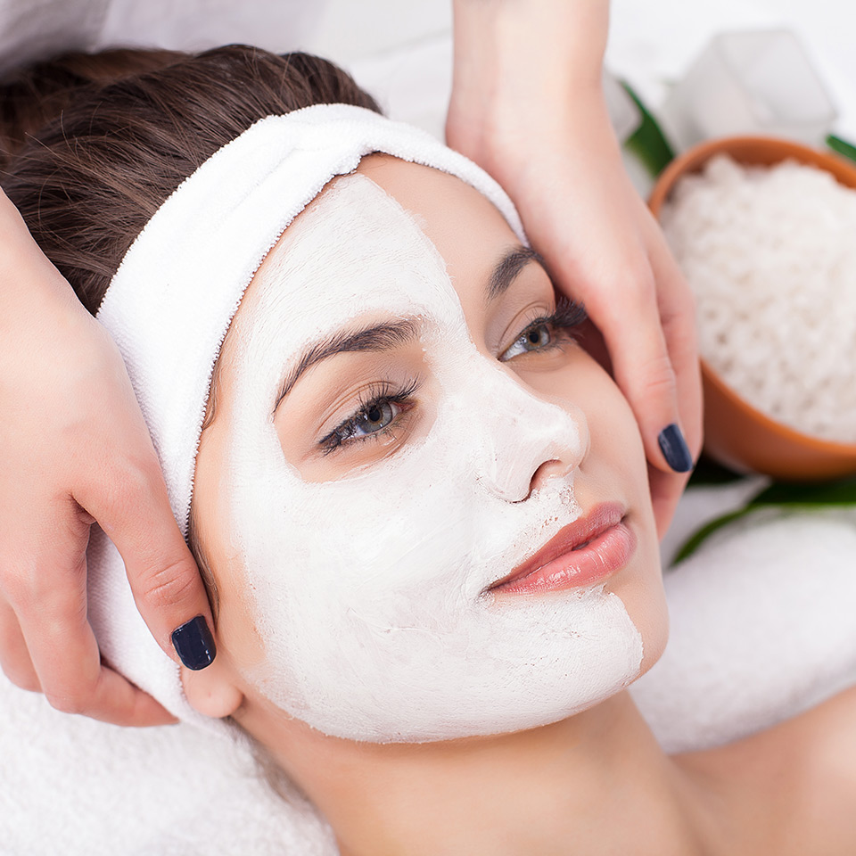 Woman wearing half of a facial mask