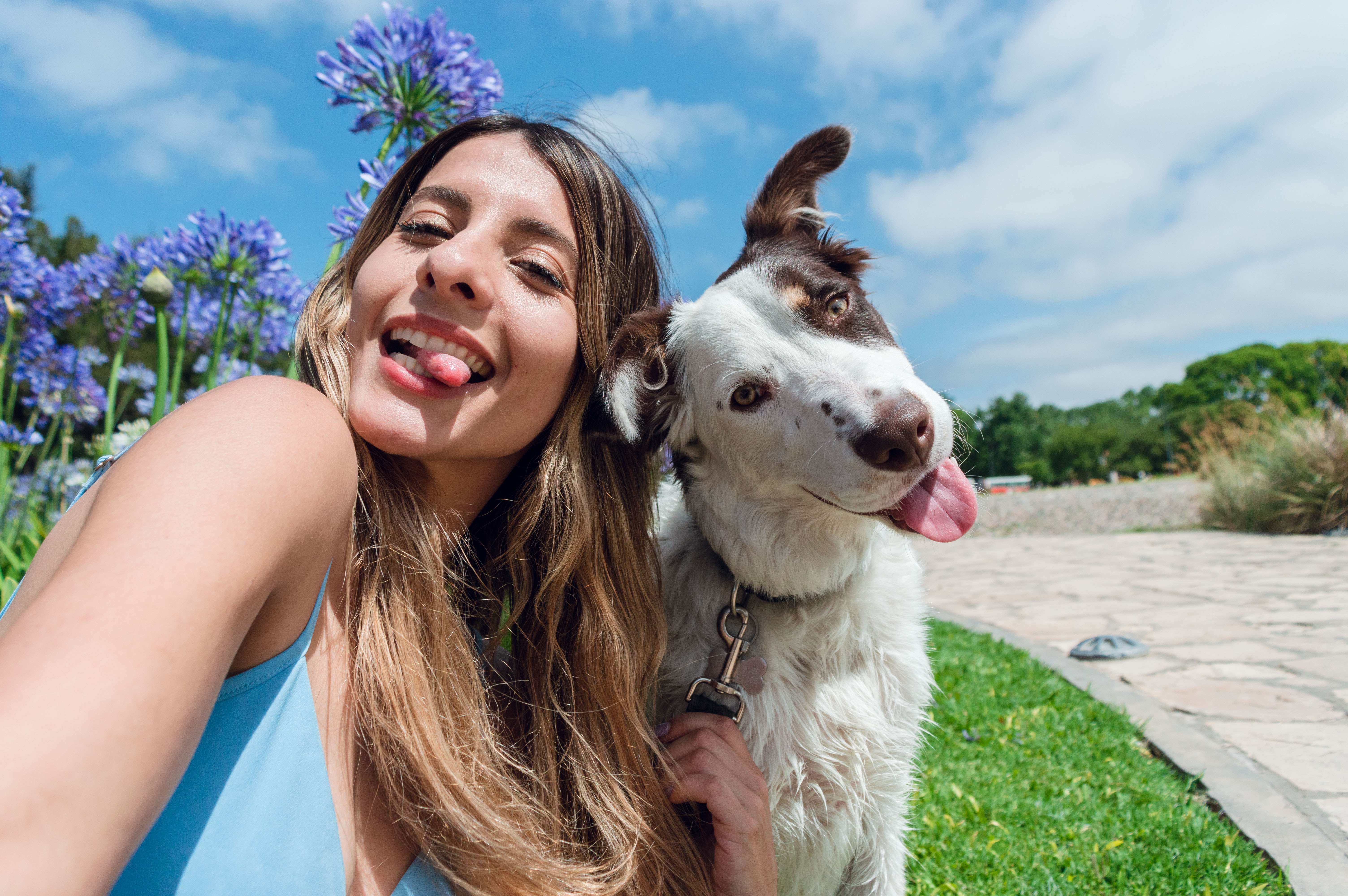 Woman and dog sticking their tongue out