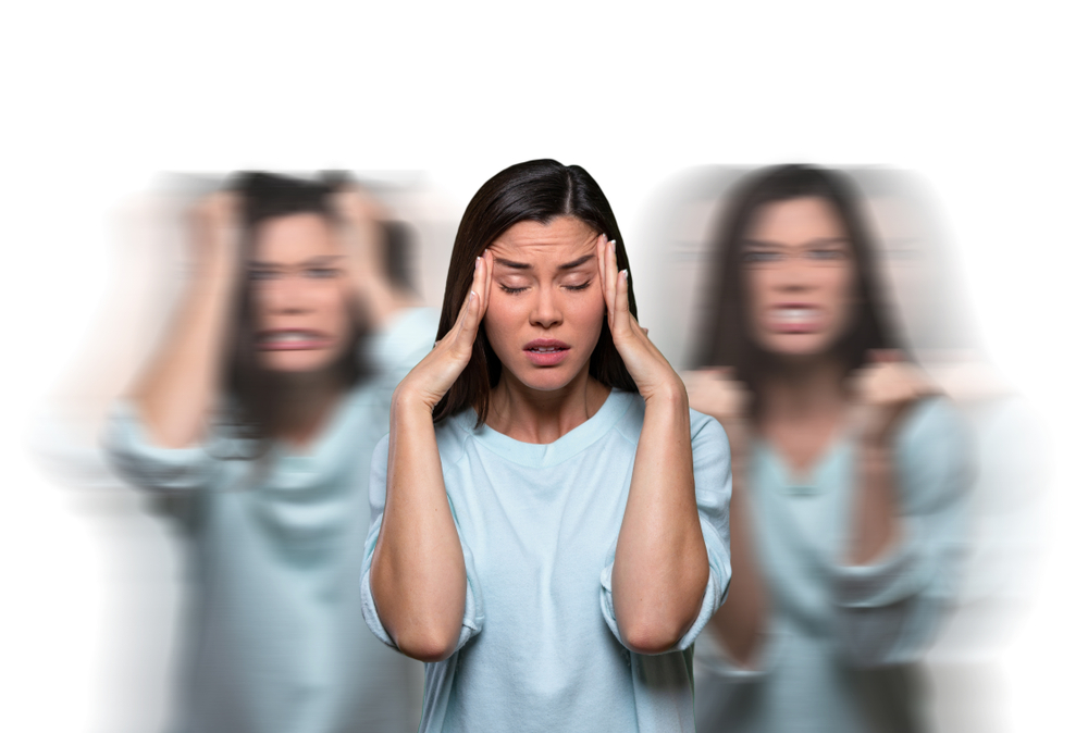 A woman with her eyes closed and hands on her temples, a copy of her on either side blurred, one frustrated and one angry