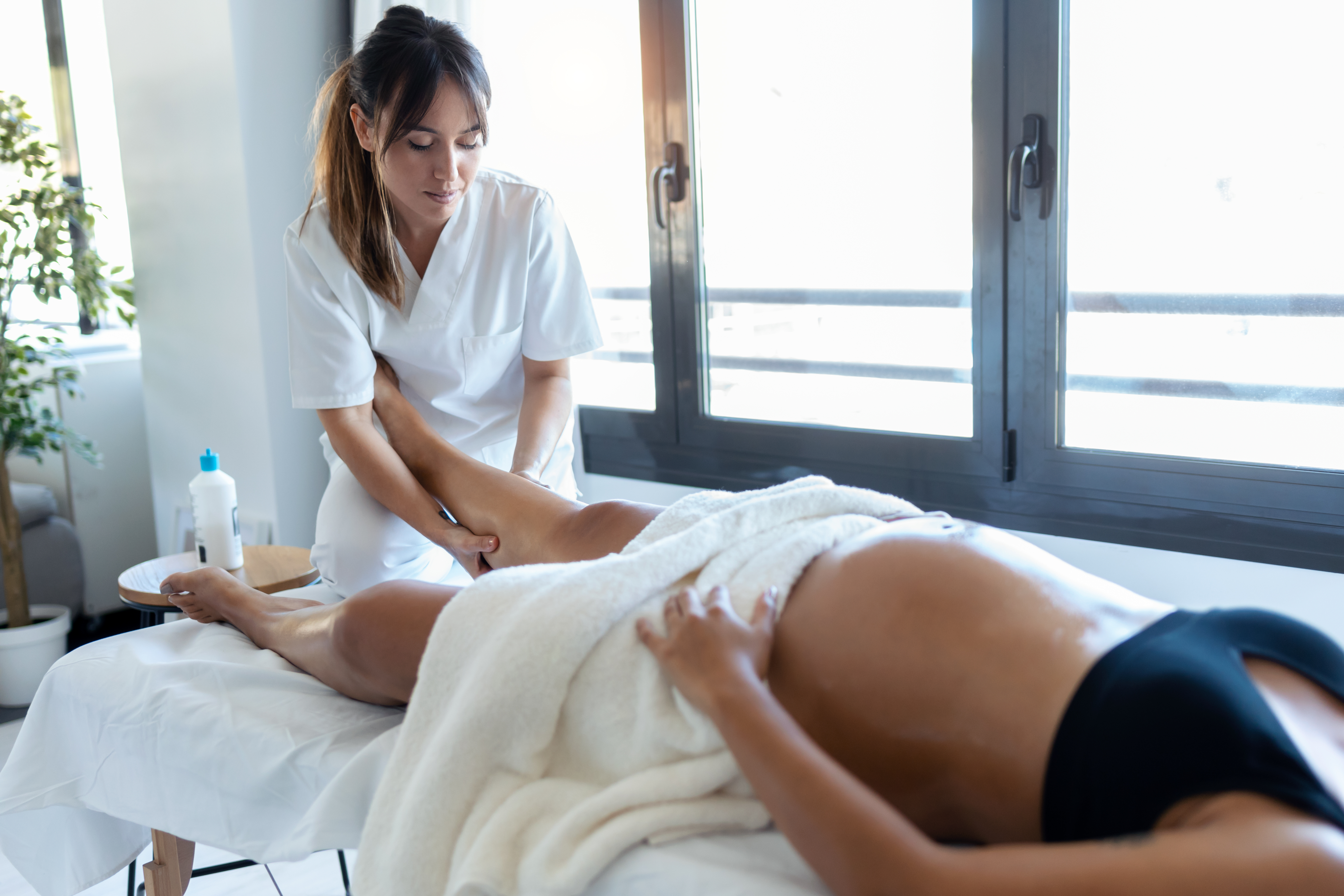 A pregnant lady receiving a reflexology treatment