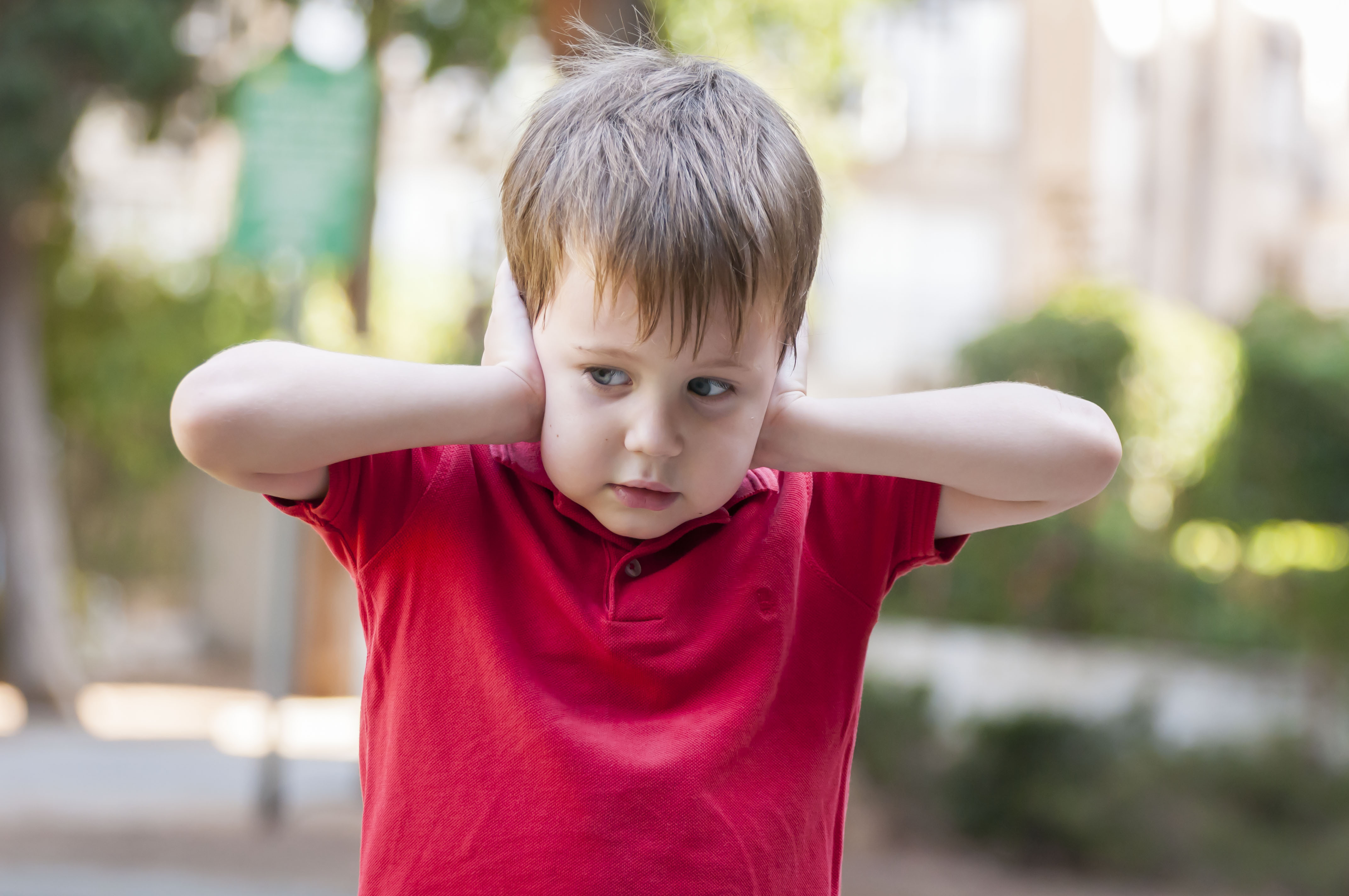 Toddler with autism covering his ears