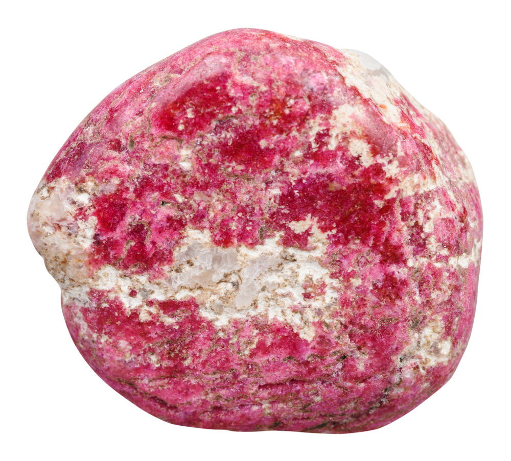 A piece of Thulite on a white background
