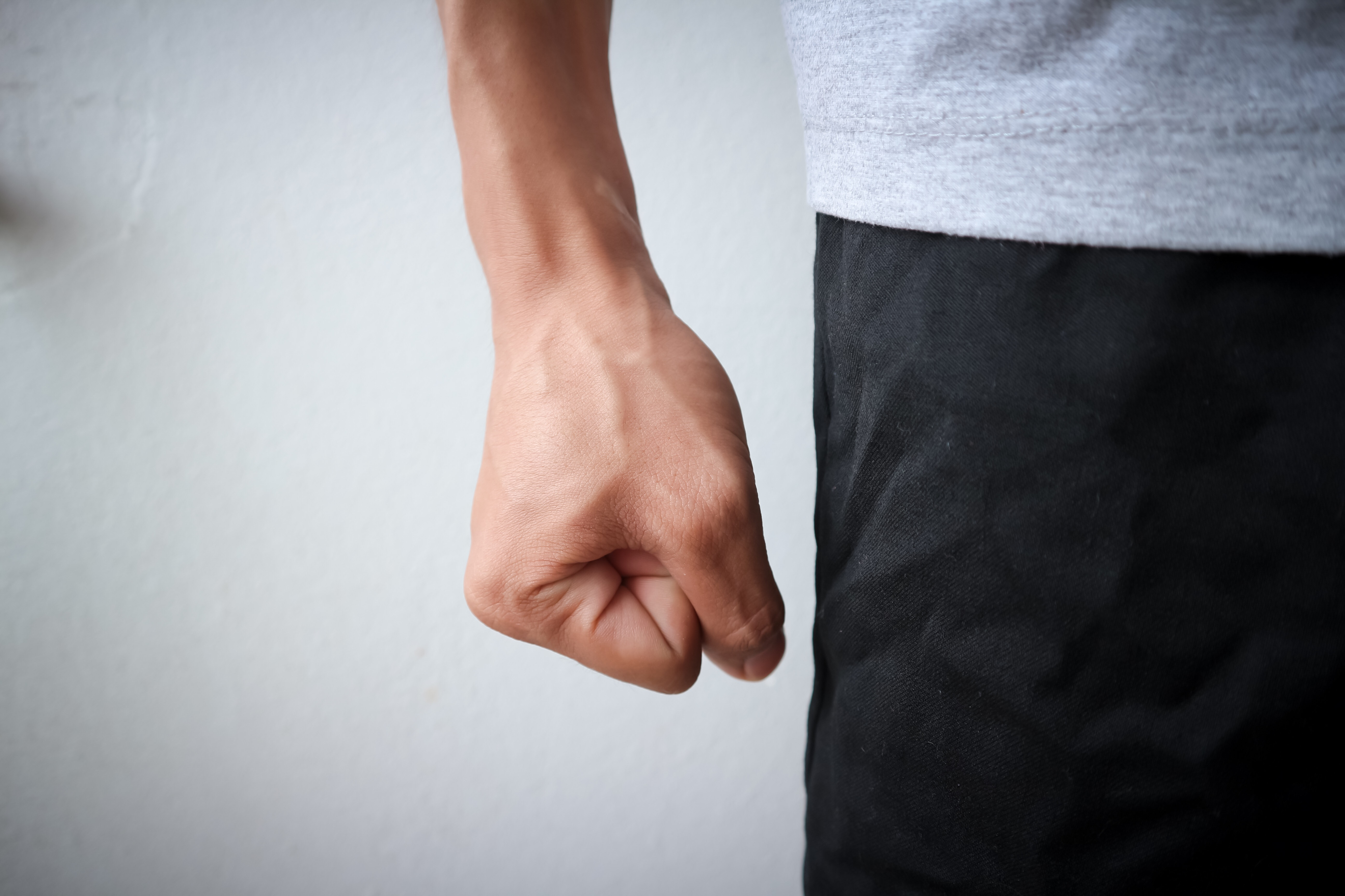 Person clenching their fist anger management