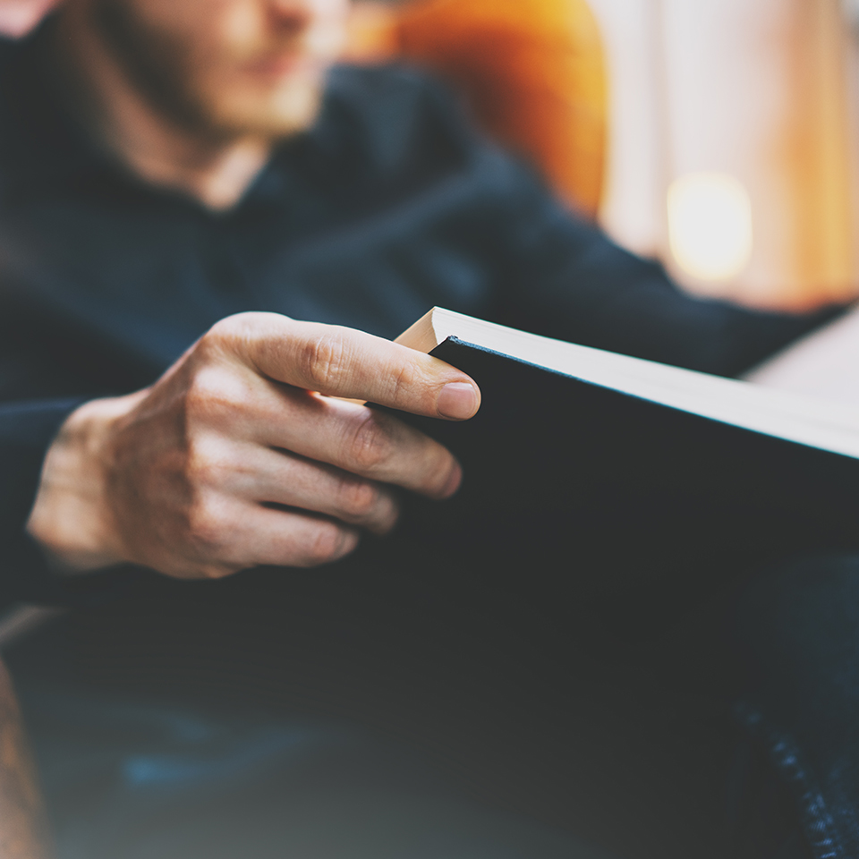 Man sat down reading a book