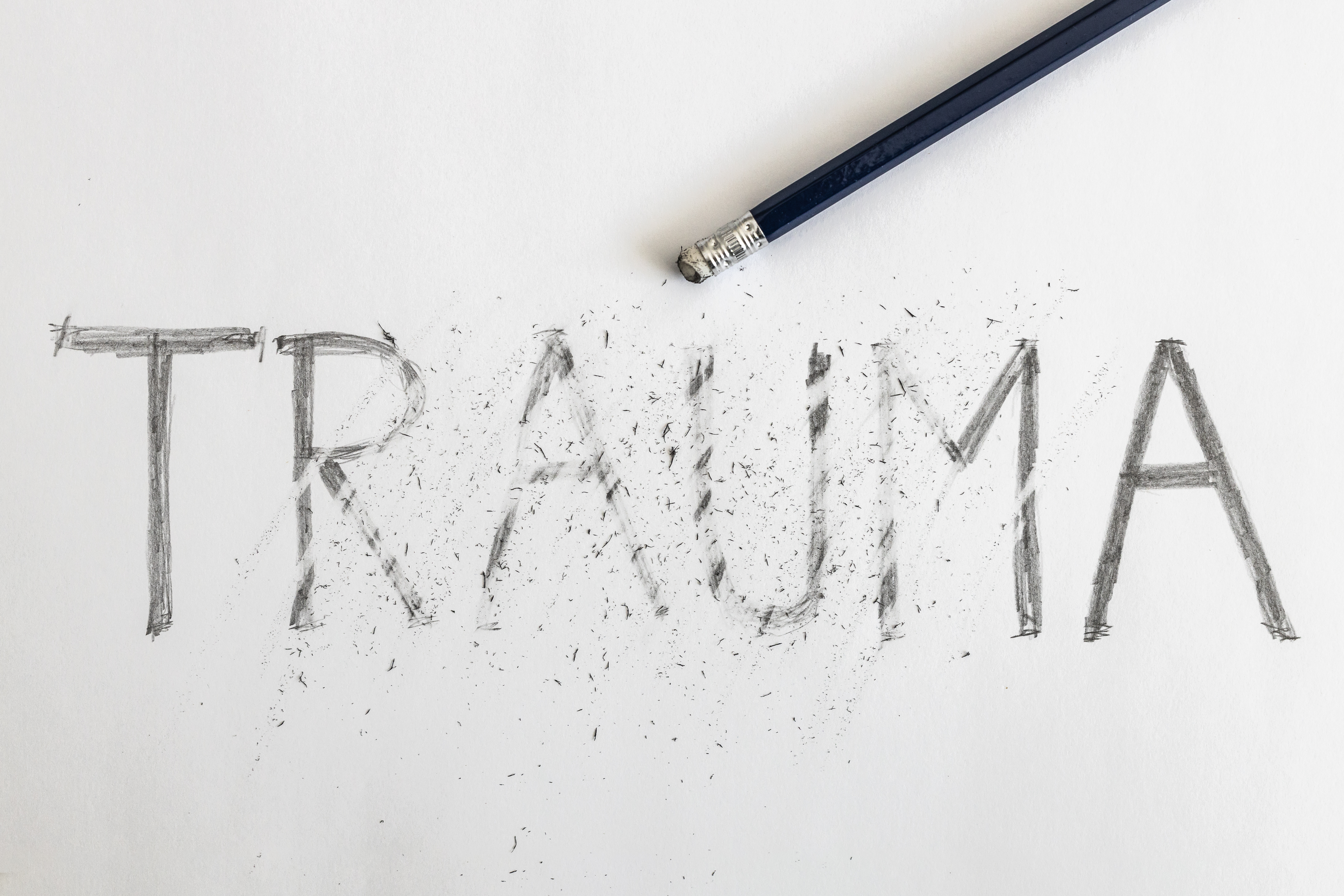 The word trauma written in pencil, with some of it rubbed out