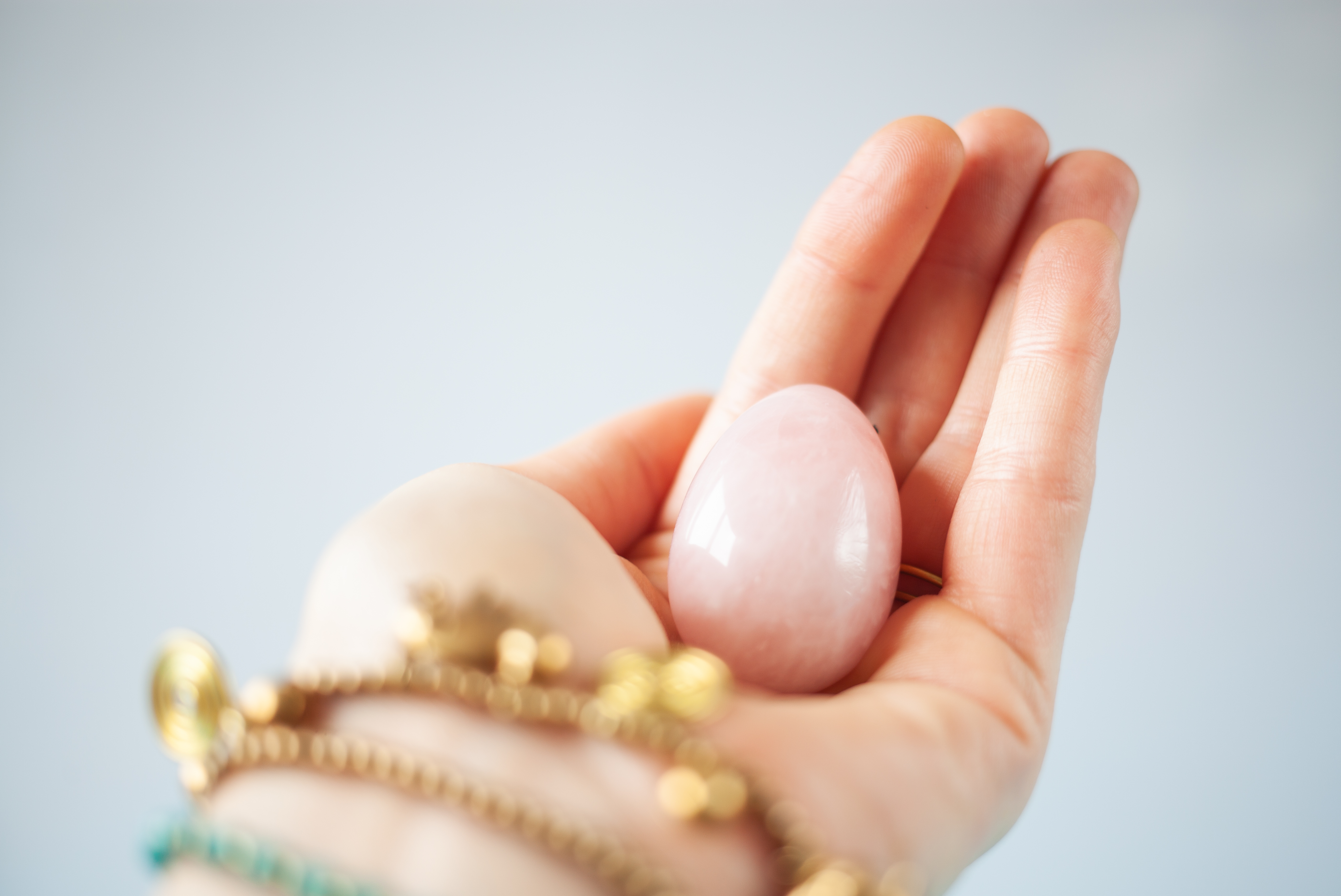 Woman holding a pink egg to symbolise the womb and fertility