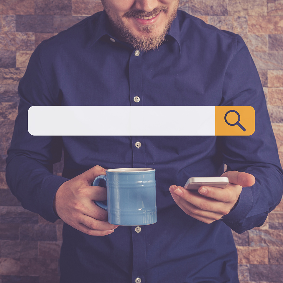 Man holding a phone using a search engine