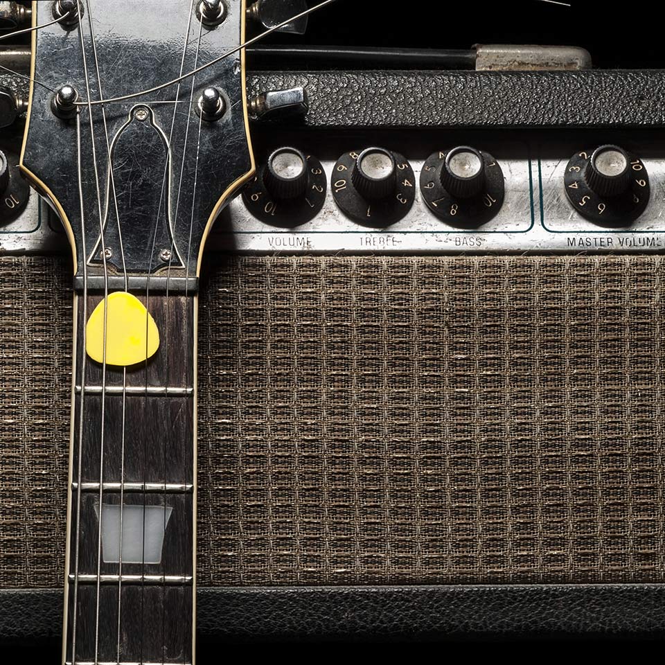 Electric guitar leant up against a guitar amplifier