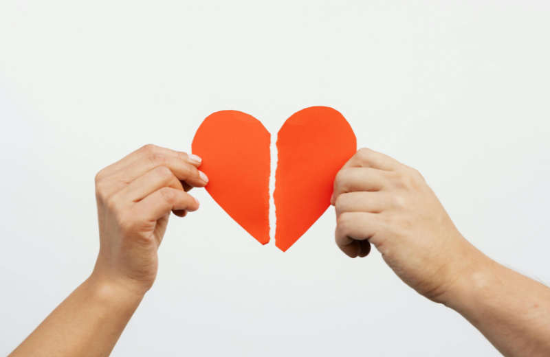hands holding broken heart