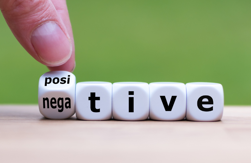 Image of someone turning the word negative into positive.