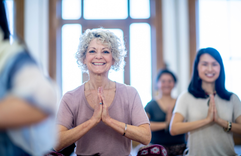 smiling older woman at yoga class