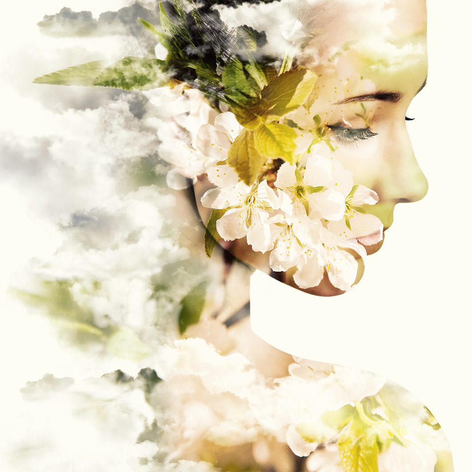 Double exposure portrait of young woman and blooming flowers