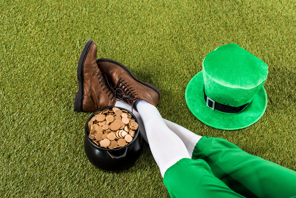 A leprechauns feet and hat next to a pot of gold