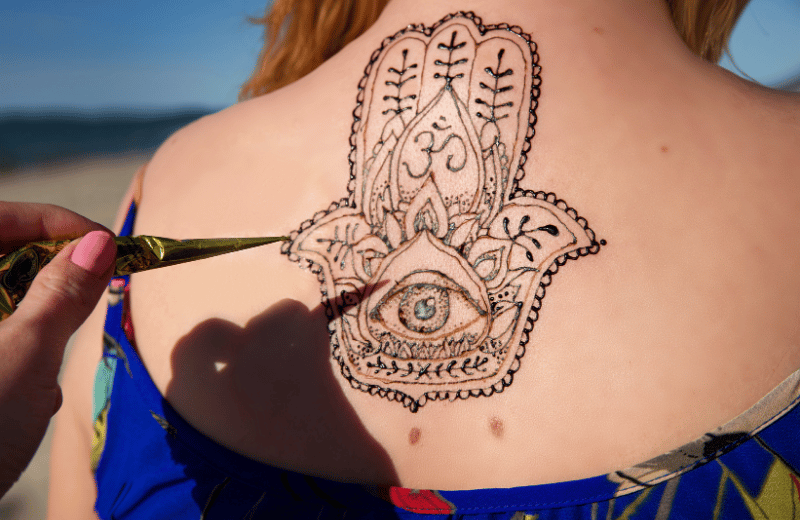Hamsa Tattoo on a lady's upper back