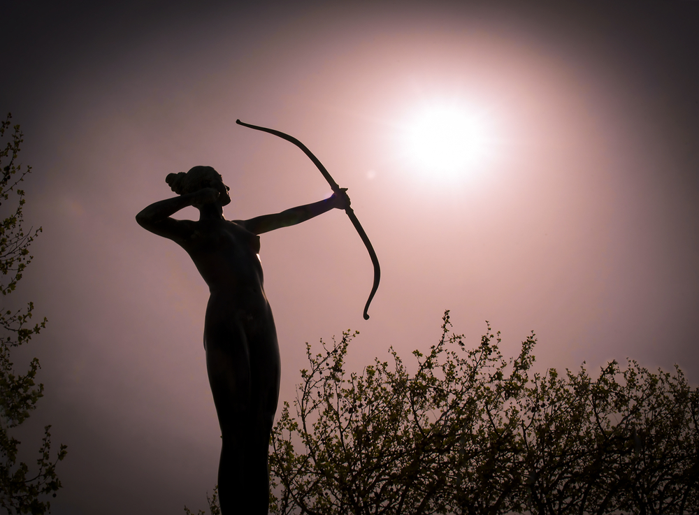 Silhouette of a figure with a bow and arrow