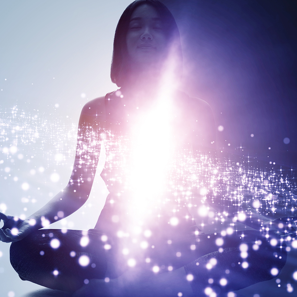 Woman in a meditating pose overlaid with a space scene.