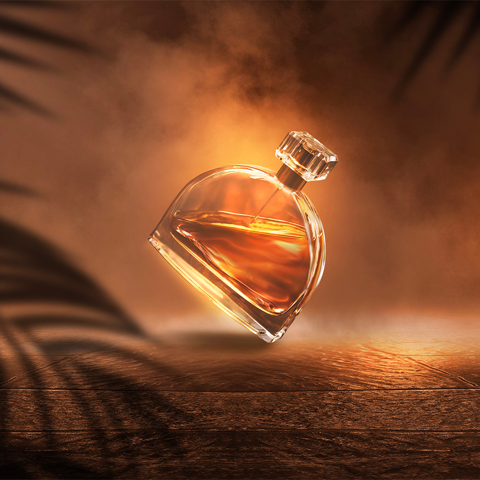 Perfume bottle behind palm trees