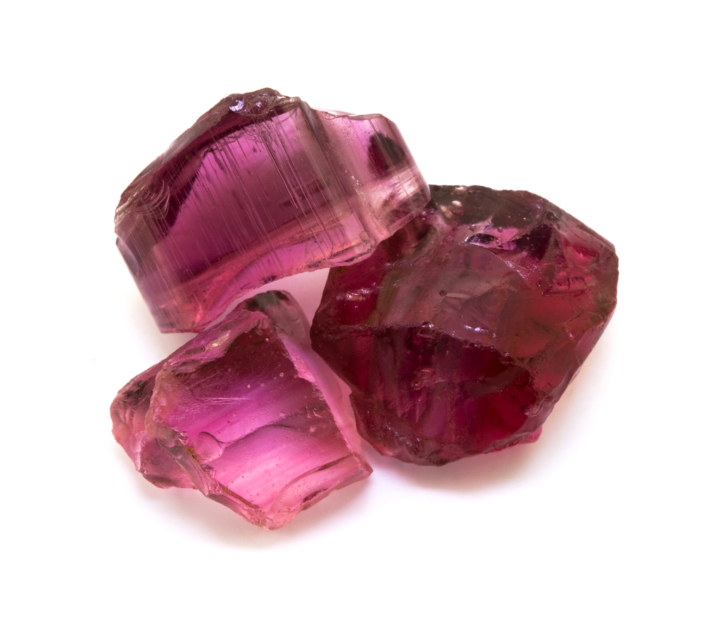 Three pieces of Rubellite on a white background