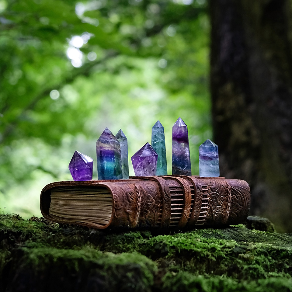Crystals on top of a spellbook in a forest
