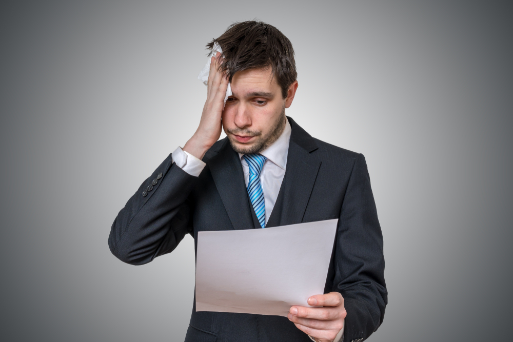 Man practicing a speech with a tissue dabbing at the sweat on his head