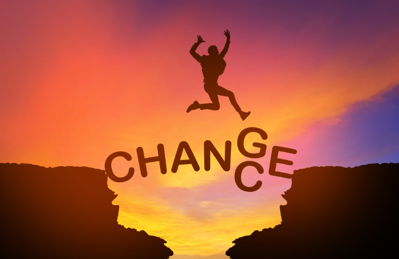 An image of someone jumping over the word 'change'