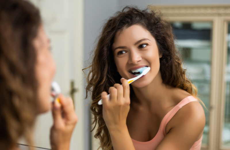 An image of someone brushing their teeth.