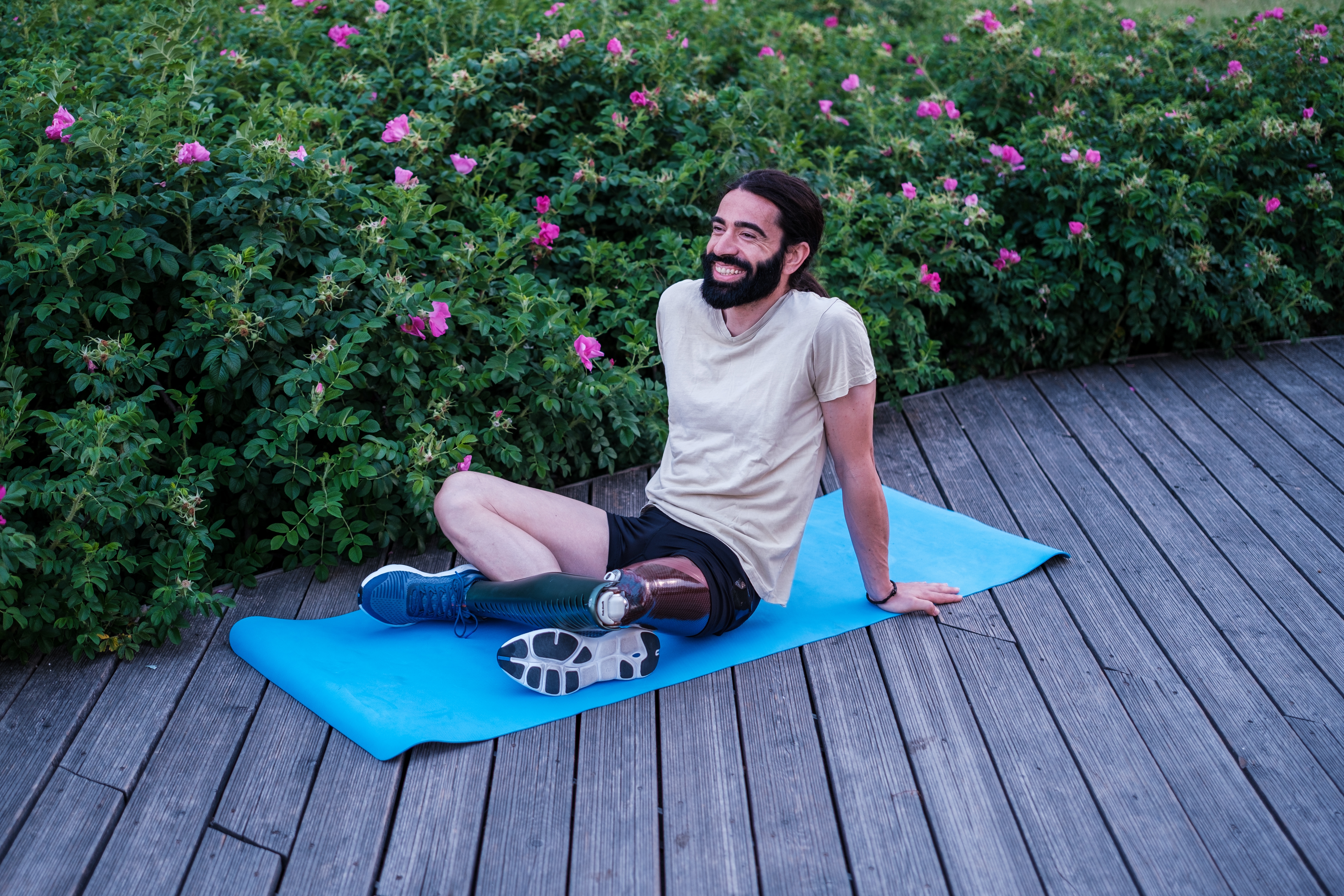 Man with artificial leg on yoga mat