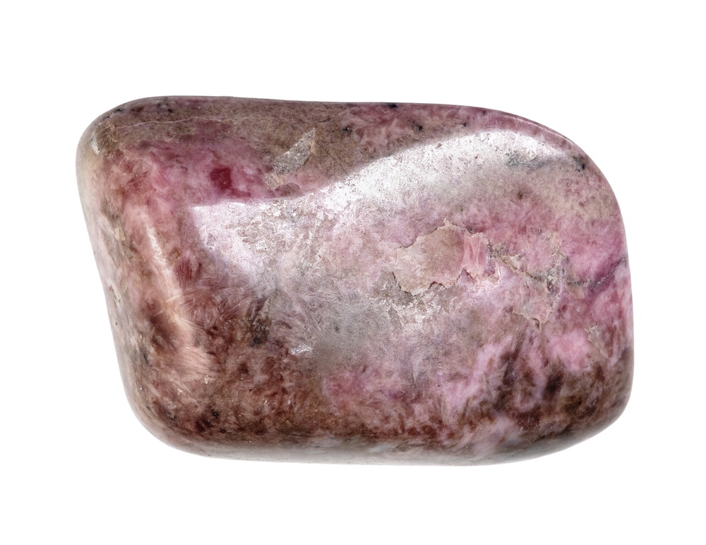 A piece of Peony Pink Pyroxmangite on a white background