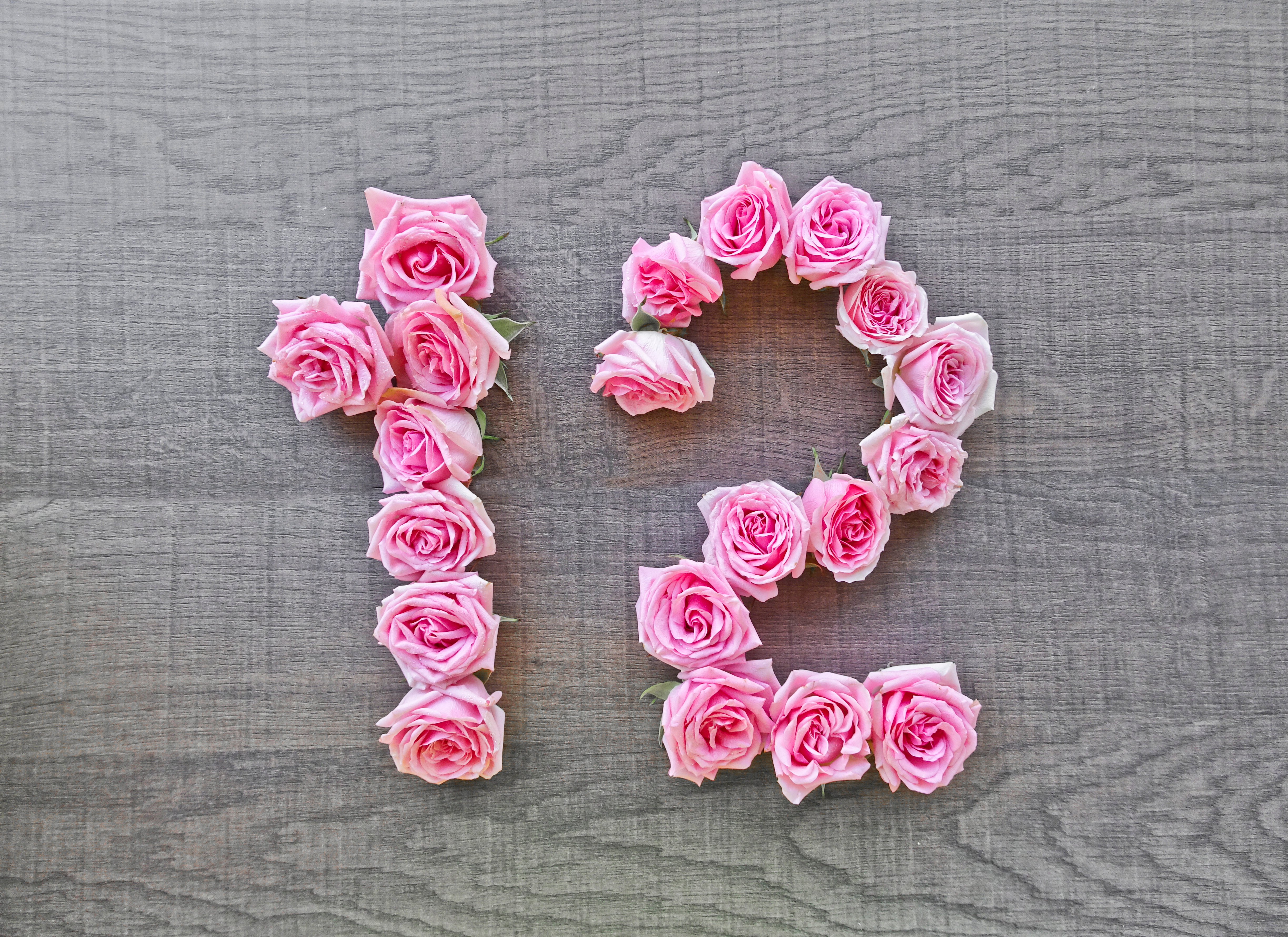 The number 12 written in pink flowers