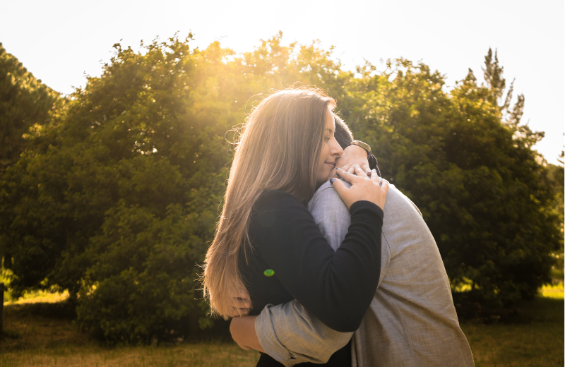 couple hugging in park