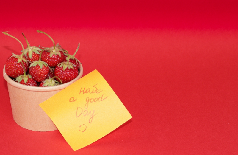 tub of strawberries and positive note