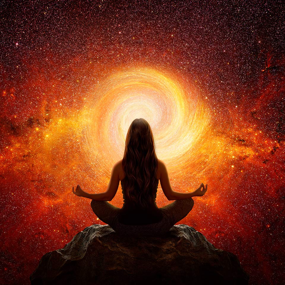 Figure in a meditation pose in front of a light