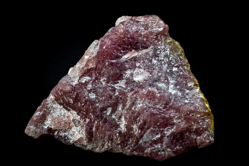 Raw Pink Aventurine on a black background