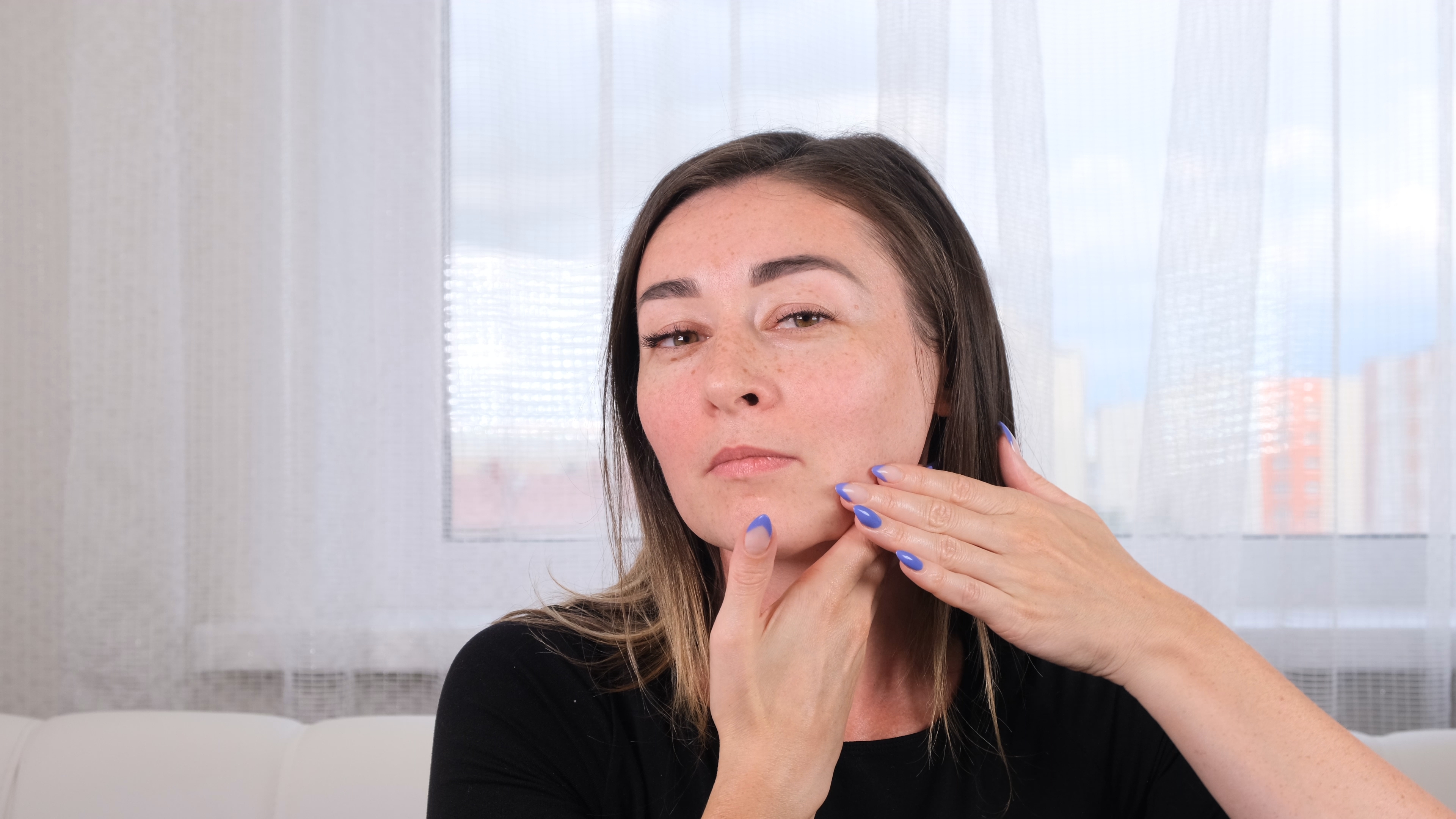 Woman giving herself a face massage