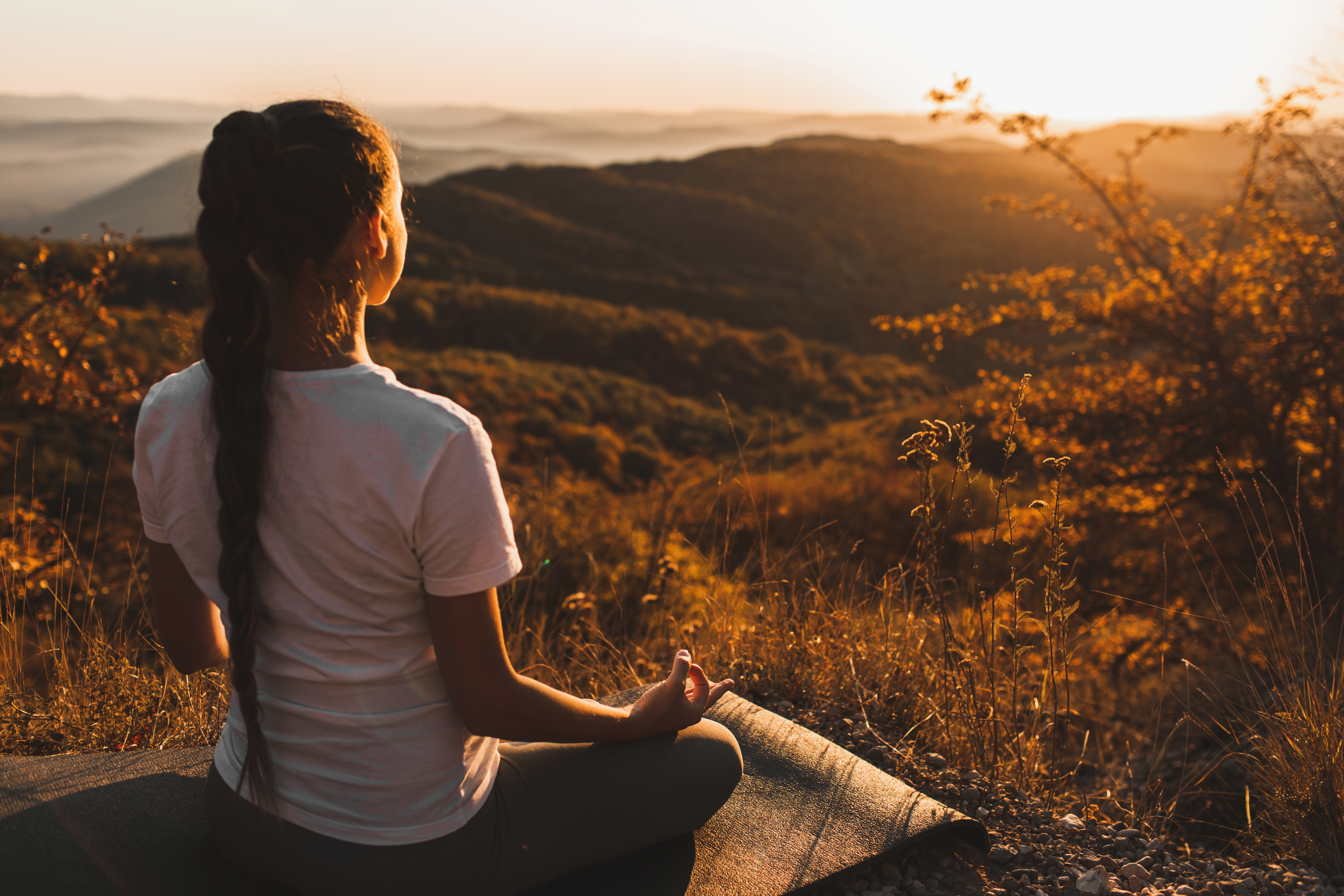 Woman meditating in the mountains