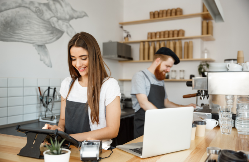 Small business owners working in a cafe.