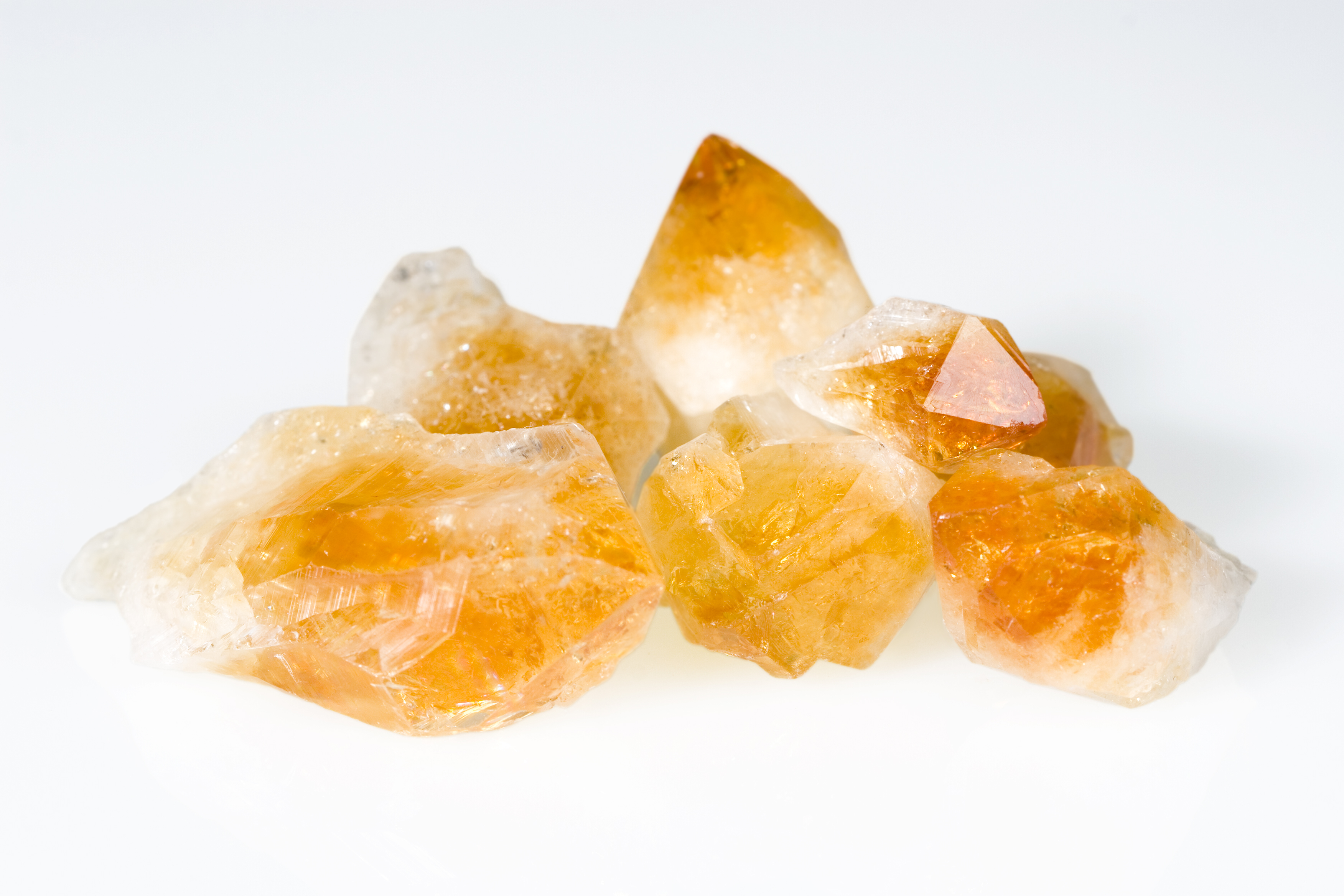 Multiple pieces of Citrine on a white background