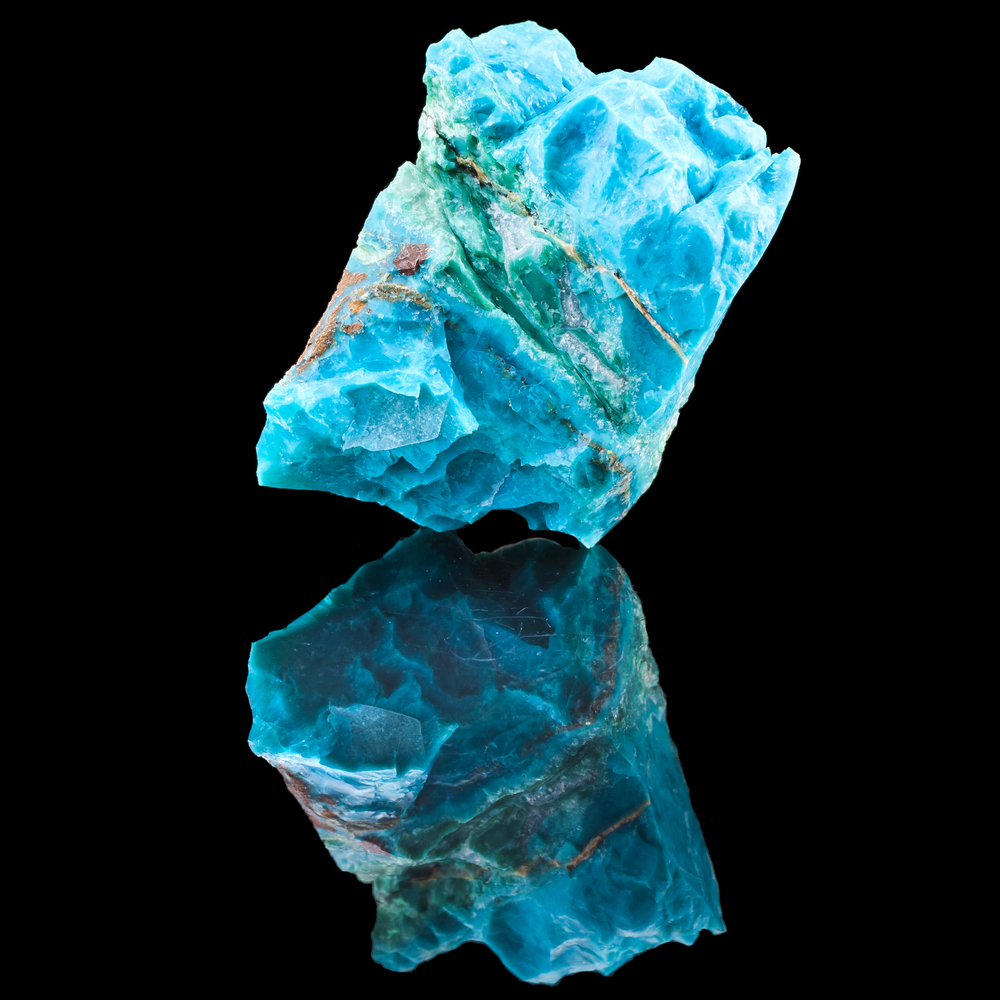 A piece of Chrysocolla on a black background