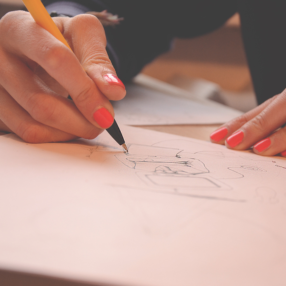 Close-up of a hand grasping a pencil, making a drawing