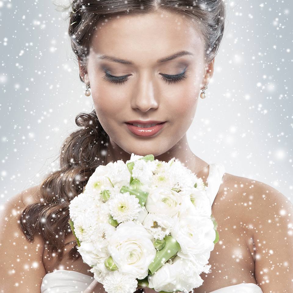 Bride holding a bouquet of white roses