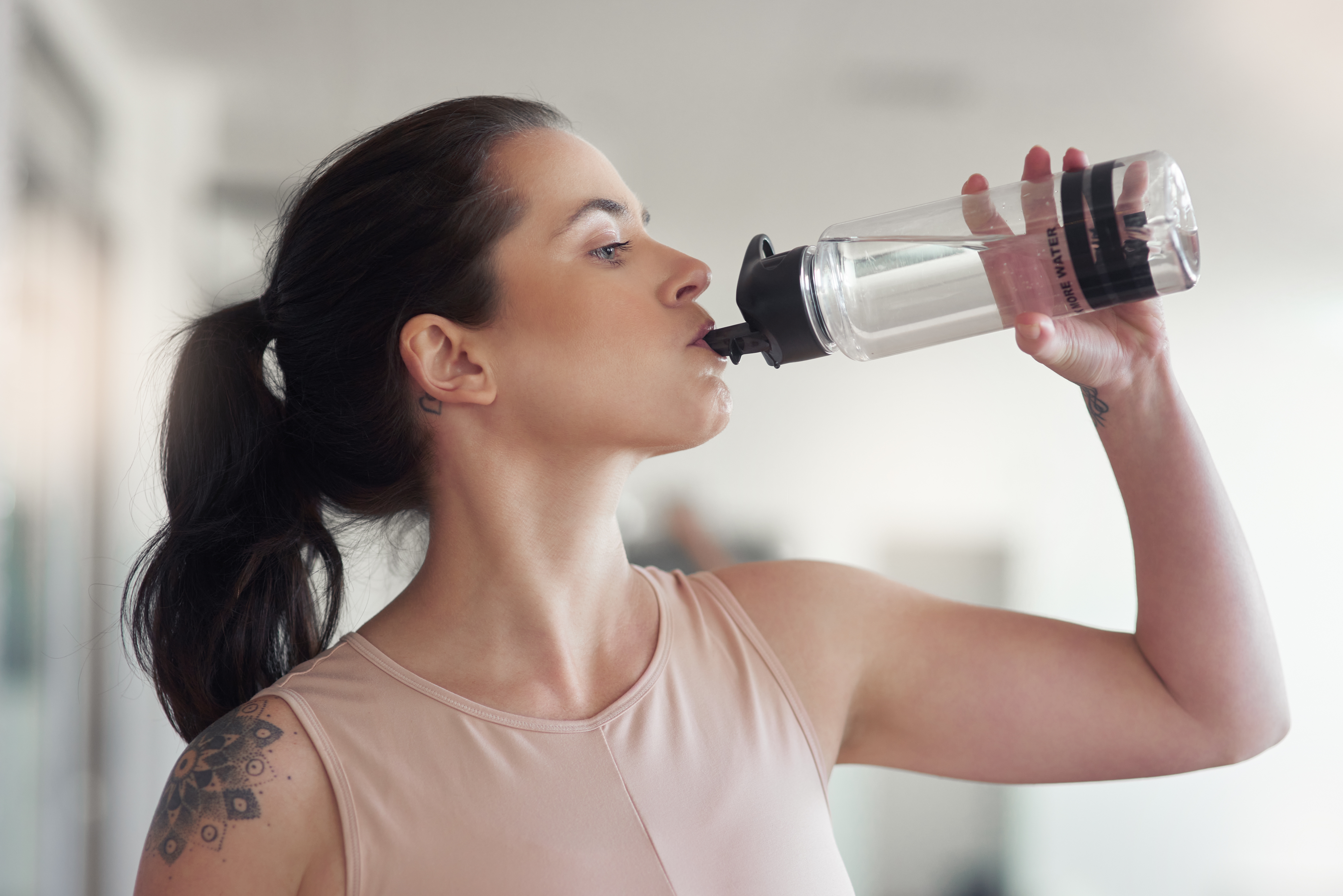 Someone drinking water from a bottle