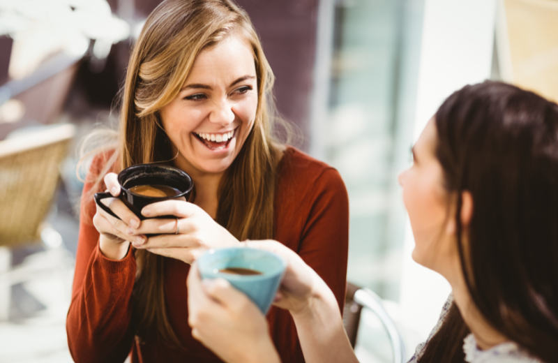 two women chatting with coffee