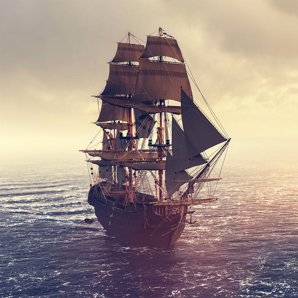 Pirate ship sailing on the ocean at sunset.