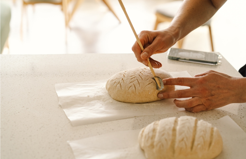 person scoring lines into sourdough