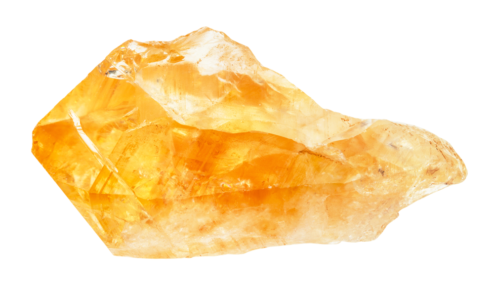 A piece of raw Citrine on a white background