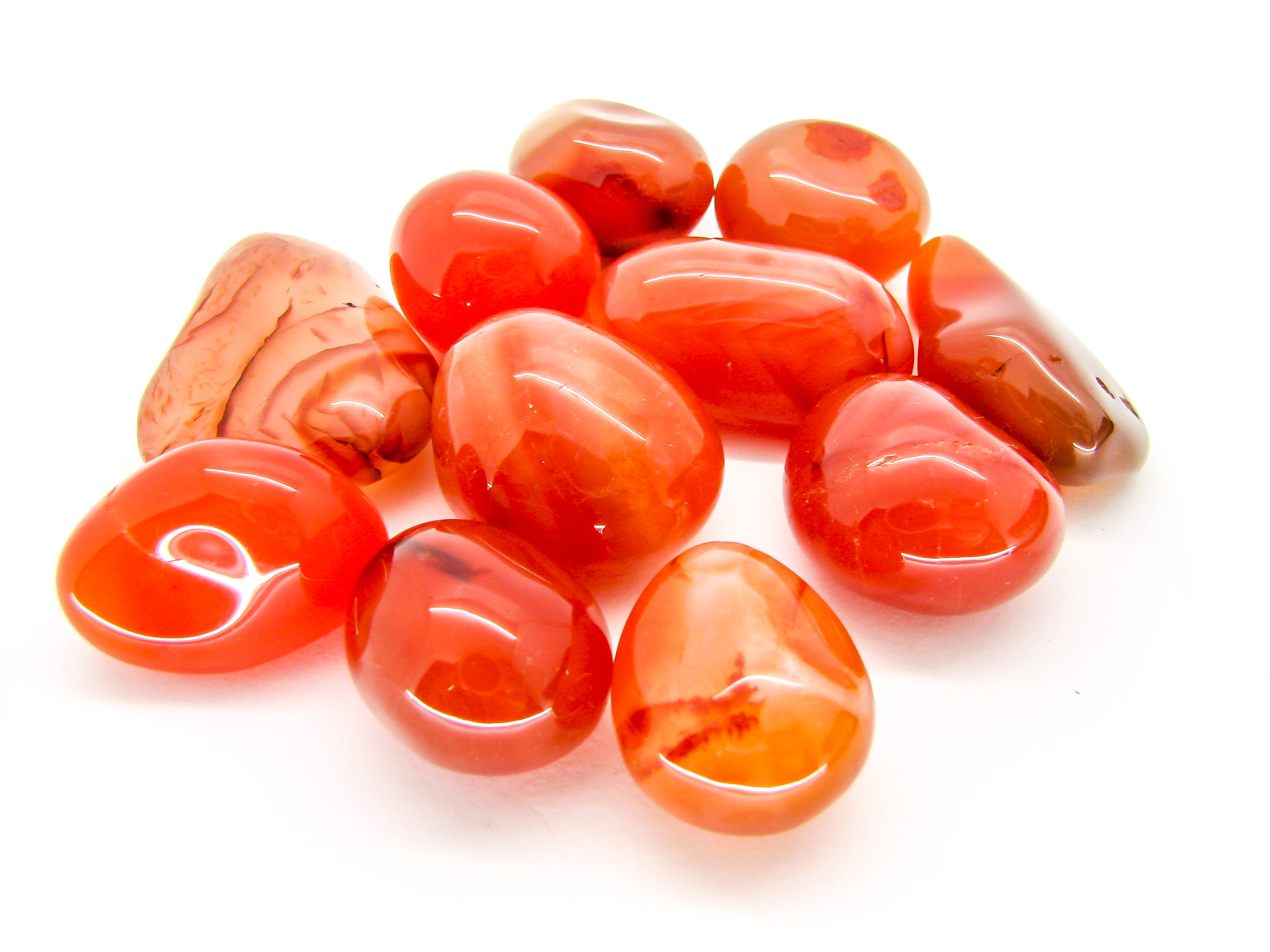 Multiple pieces of Carnelian on a white background