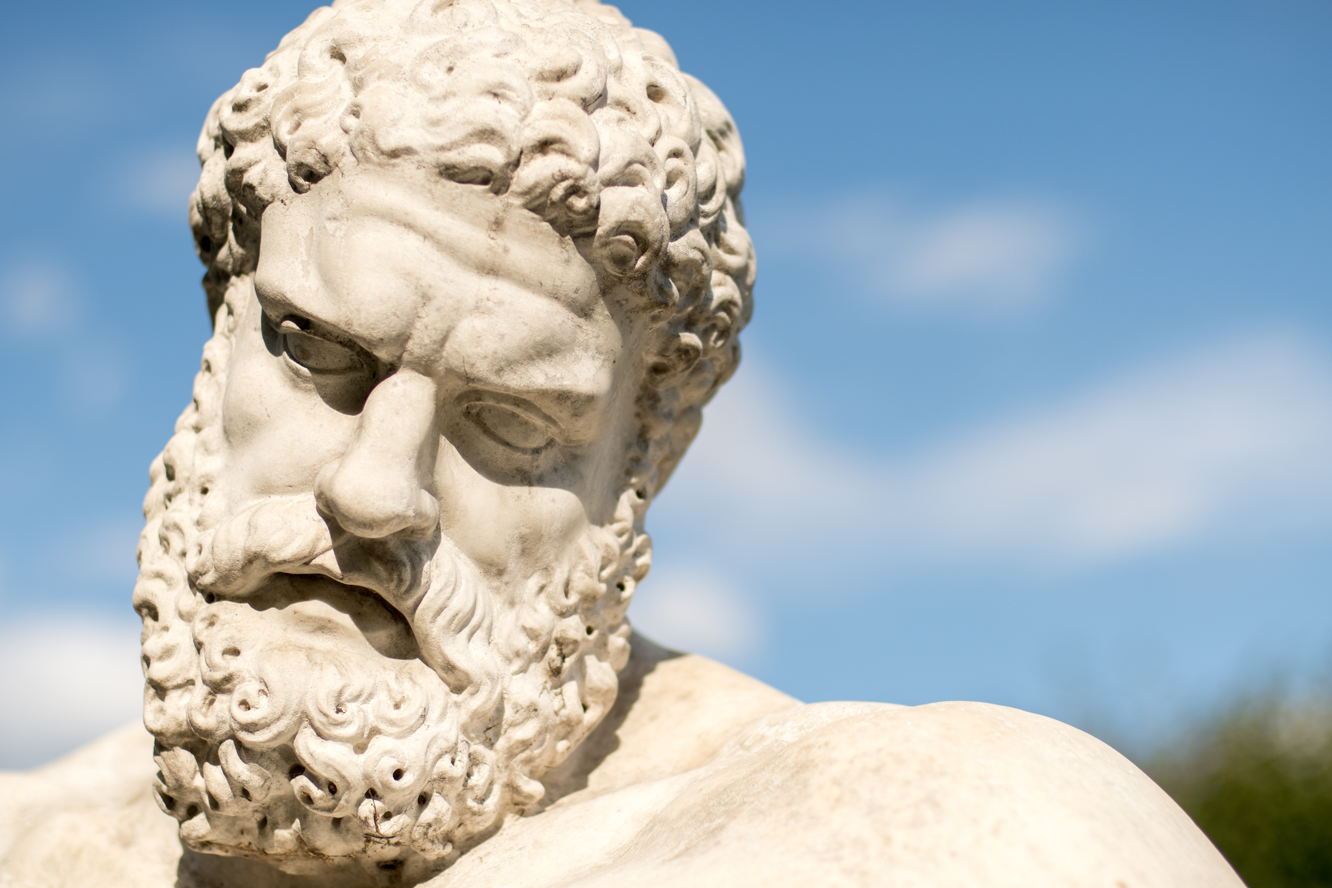Close up of the face of a statue of Hercules