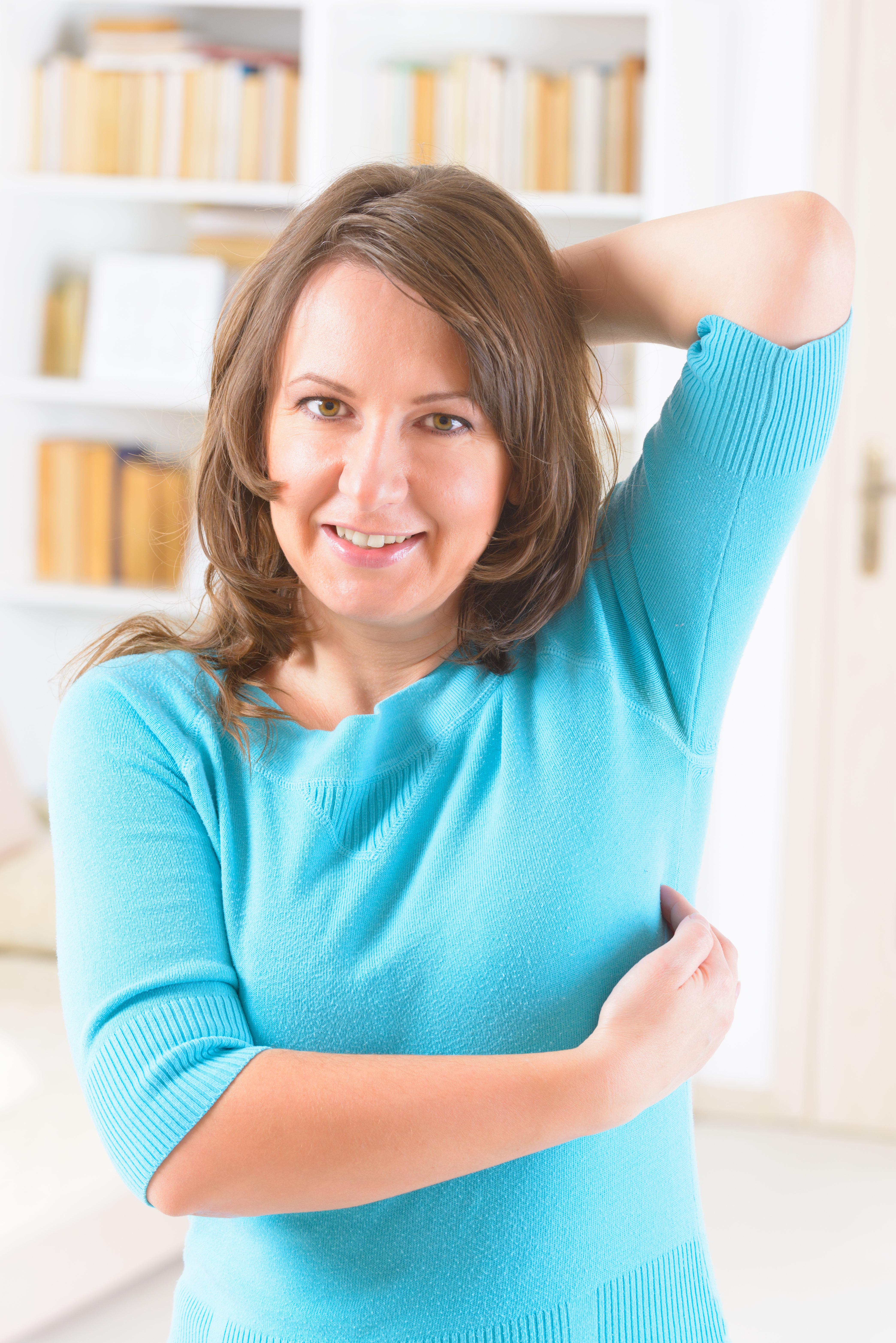 Woman tapping the inside of her armpit