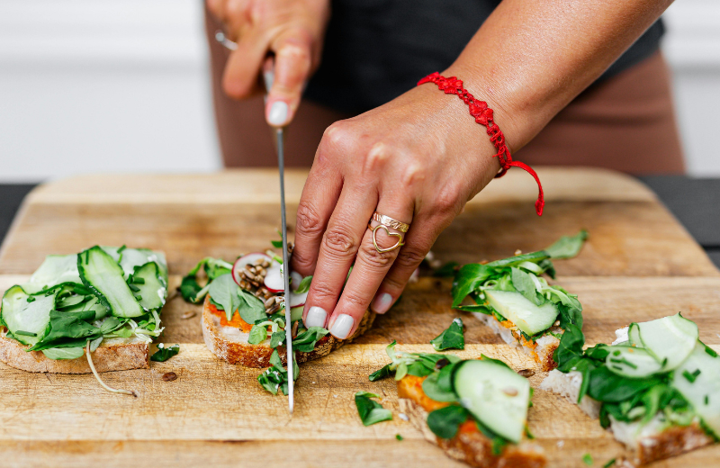 Person cutting healthy bread and salad